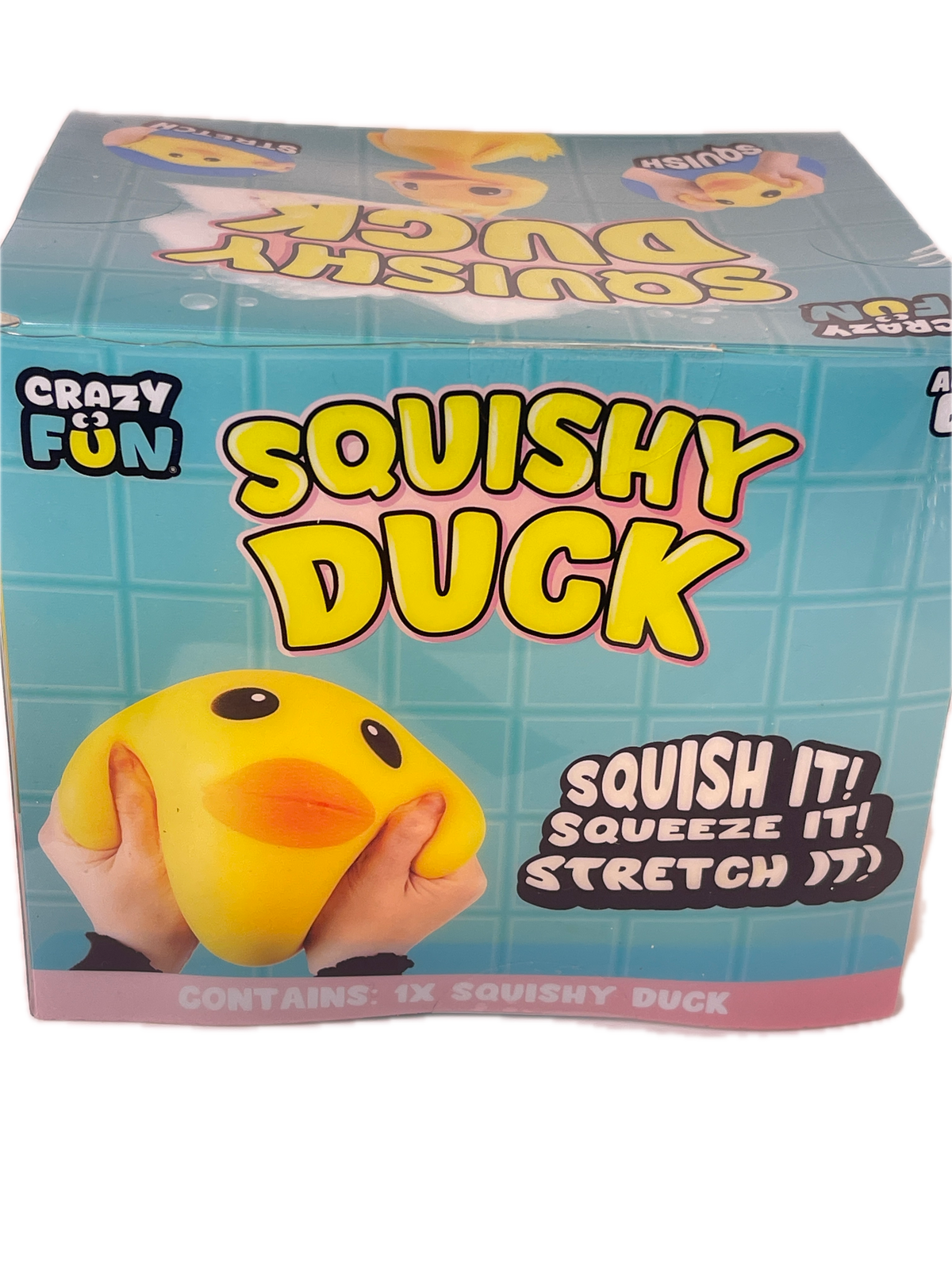 A boxed 'Squishy Duck' toy by Crazy Fun, shown at an angle against a white background. The packaging is light blue with yellow, black, and pink graphics, and features a photo of hands squeezing a yellow duck toy.