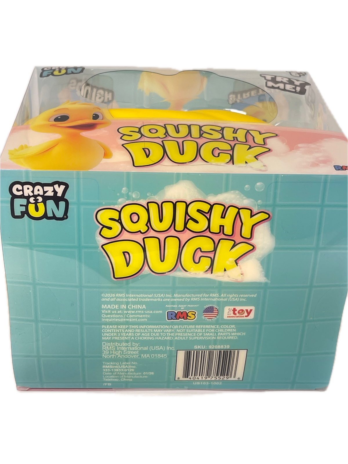 A boxed toy product labeled 'Squishy Duck' by Crazy Fun, shown at an angle on a plain white background. The package is mostly light aqua blue with large yellow text, a photo of a yellow duck, and product details including a barcode and small toyist logos.