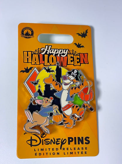 A Disney Pins Happy Halloween limited edition enamel pin on its original orange backing card. The pin features Tigger, Digger, and Piglet in Halloween costumes against a black and yellow moon background with bats.