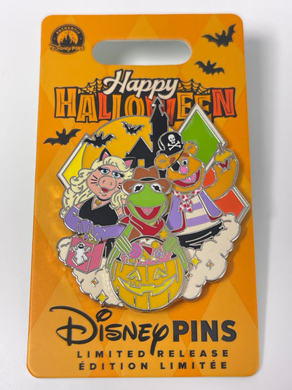 A Disney Mupp Halloween-themed enamel pin on its original orange backing card. The pin features Kermit the Frog, Miss Piggy, Fizz Piggy, and Gonzo in Halloween costumes.