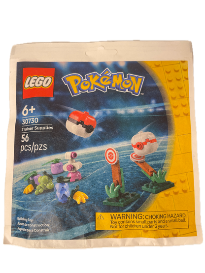 A sealed LEGO toy package for the LEGO Pokémon Travel Supplies set 30759, featuring a colorful printed insert card with LEGO and Pokémon branding, age 6+, 36 pieces, and a choking hazard warning on a white plastic bag.