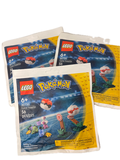 Three LEGO Pokémon blind bag packs fanned out on a white background, showing the yellow and blue packaging with LEGO and Pokémon branding.