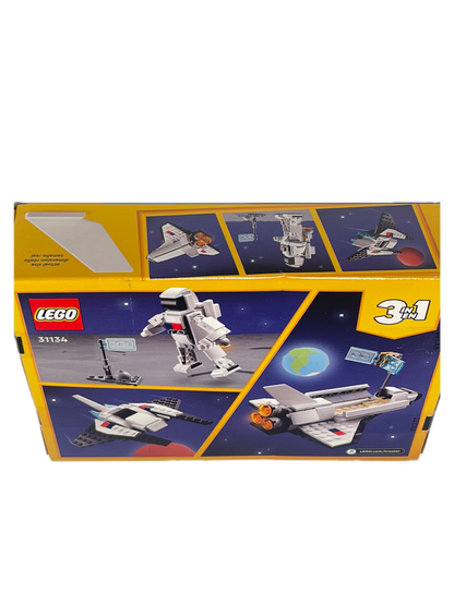LEGO 31342 Space Station 3-in-1 building set box, showing the front and side panels with illustrations of a white and gray space station, astronauts, and space scenery on a yellow background.