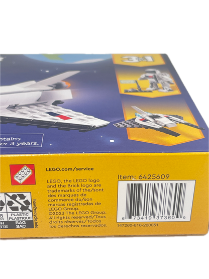 Close-up of the back of a LEGO box showing a barcode, product information text, recycling logo, and small LEGO branding on a yellow and blue package.