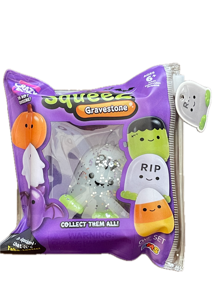 A purple bag of Squeezies Gravestone collectible squishy toys, featuring a clear window showing a white glittery squishy with green and orange accents. The packaging features cartoon graphics of Frankenstein's monster, a pumpkin, and a candy corn on a white background.