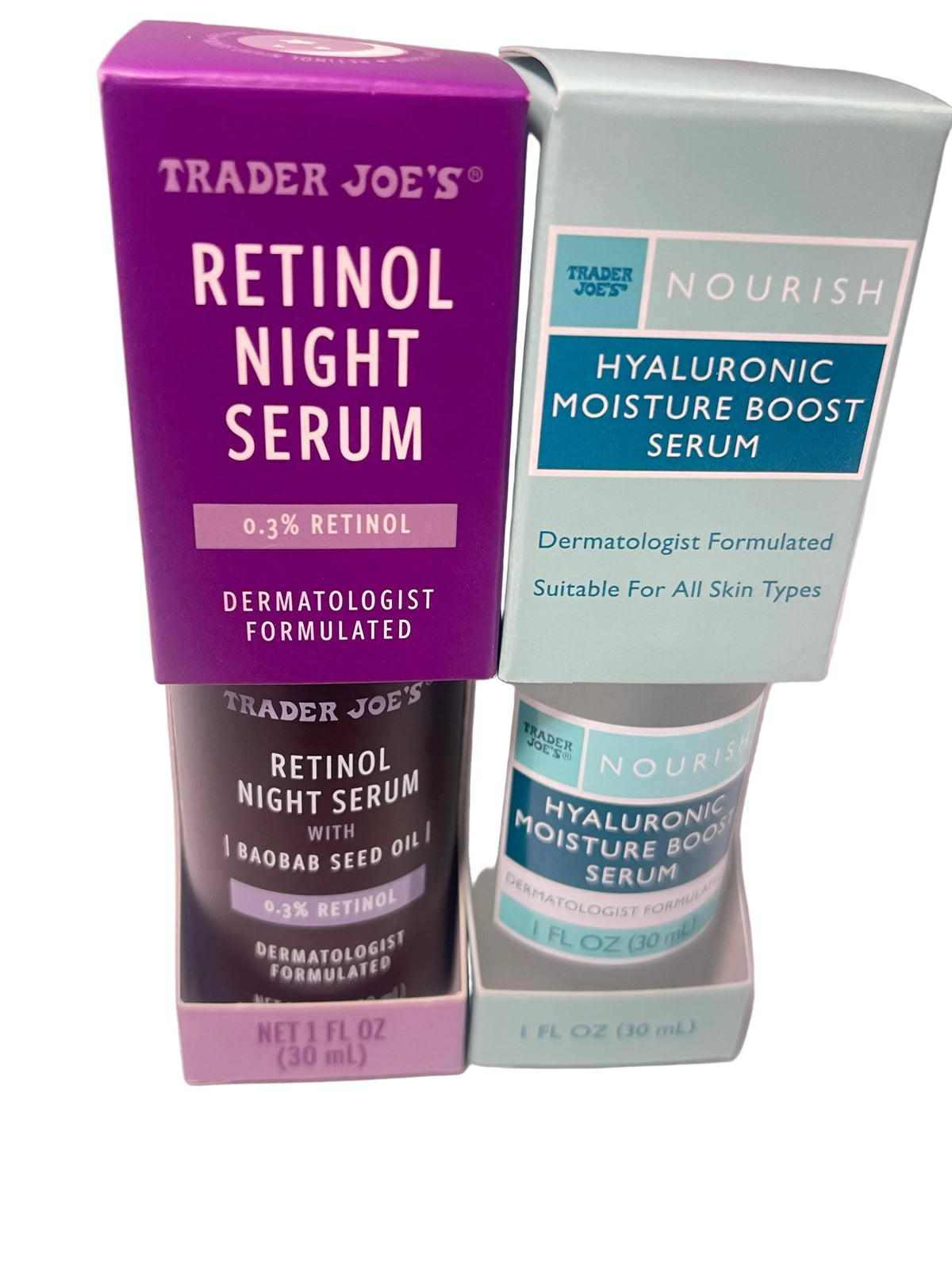 Two Trader Joe's skincare product boxes and bottles on a pale pink background: a purple box of Retinol Night Serum and a light blue box of Hyaluronic Moisture Boost Serum, with matching bottles below.