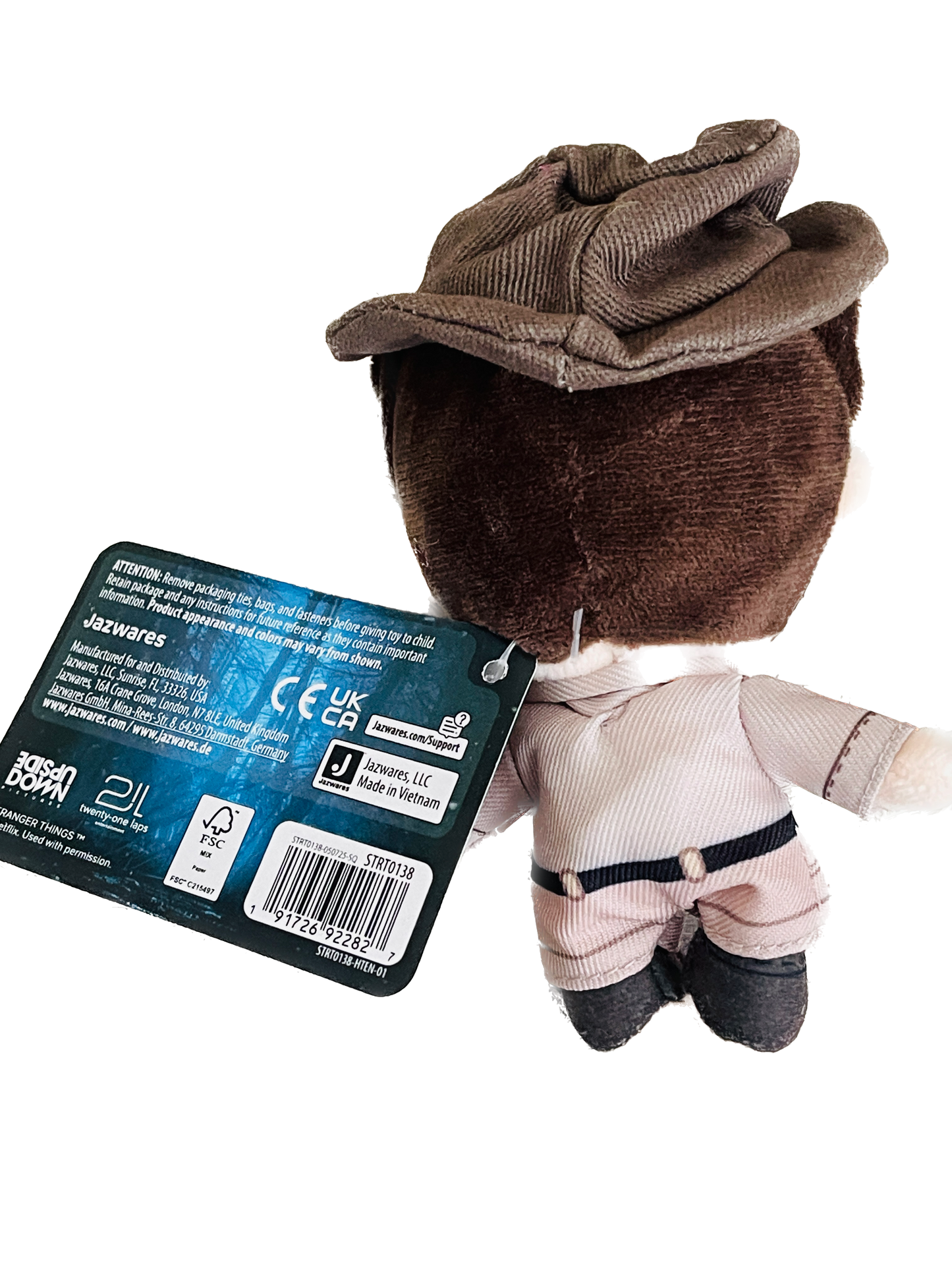 Plush toy resembling a character from 'Star Wars' with a visible tag on a white background