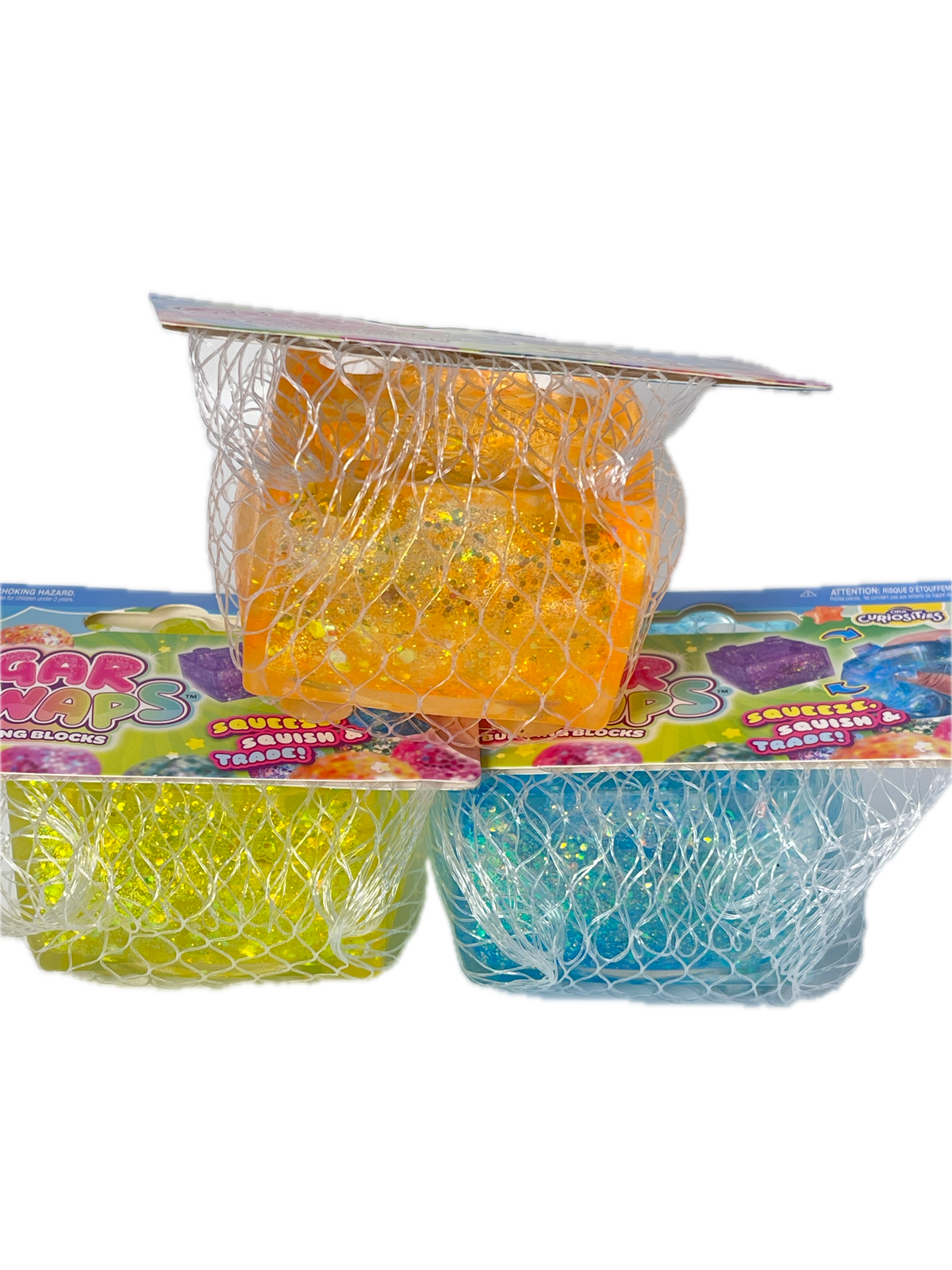 Three mesh-wrapped gel packs in orange, blue, and yellow, attached to a colorful printed backing card on a plain white background.
