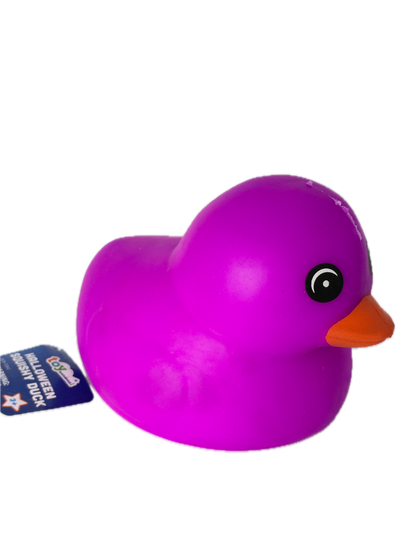 A bright purple squishy duck toy with a small orange beak and a black-and-white eye, shown on a plain white background with a blue product tag attached.