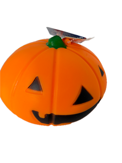 An orange squishy ack-o'-lantern toy with black carved facial features and a small green stem, shown on a plain white background with a hangtag attached.