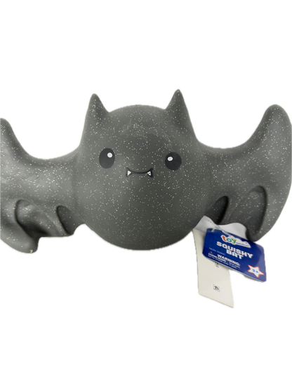 A dark gray, glitter-textured squishy bat 