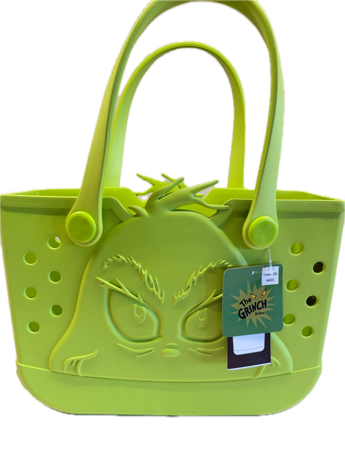 A lime green silicone handbag shown on a plain white background, featuring a Grinch face design on the front, circular ventilation holes, and a hanging product tag.