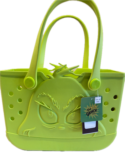 A lime green silicone handbag shown on a plain white background, featuring a Grinch face design on the front, circular ventilation holes, and a hanging product tag.