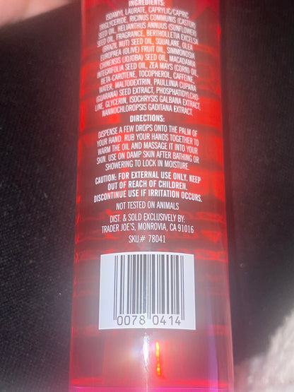 Close-up of a red product label with text and a barcode on a black background