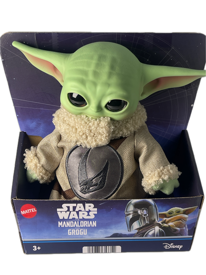 Green toy figure of a character from 'The Mandalorian' in packaging with 'Star Wars' branding.