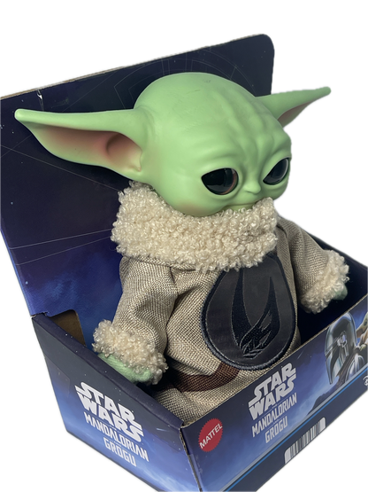Green alien plush toy with a fluffy white head in a Star Wars packaging box.
