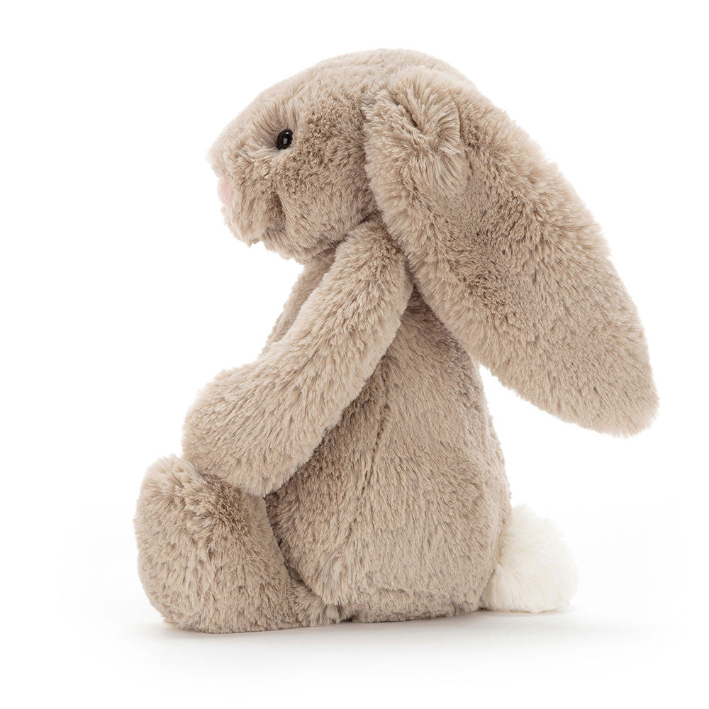 Plush bunny toy in beige color on a white background