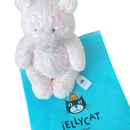 Pink plush toy on a Jellycat branded blue mat