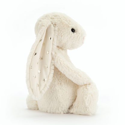 White plush bunny with a star-patterned scarf on a white background
