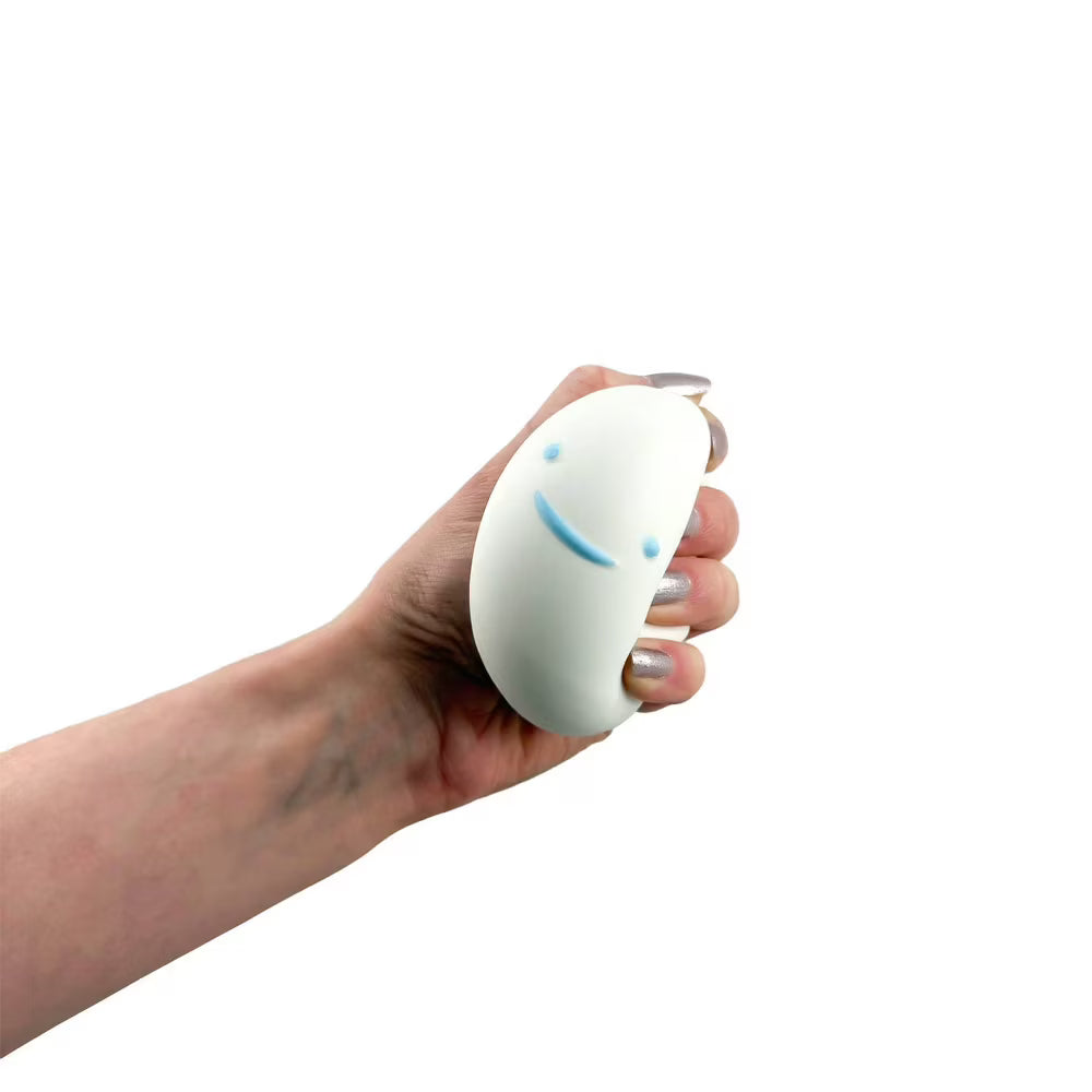 Hand holding a white stress ball with a smiley face on a white background