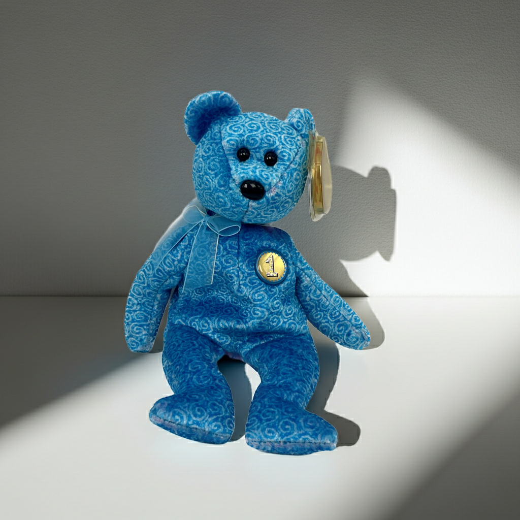 Blue teddy bear with a tag on a gray background