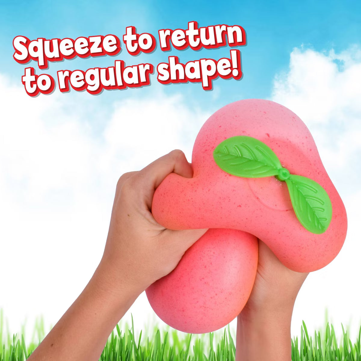 Pink squishy toy with green leaves being squeezed against a blue sky and grass background.