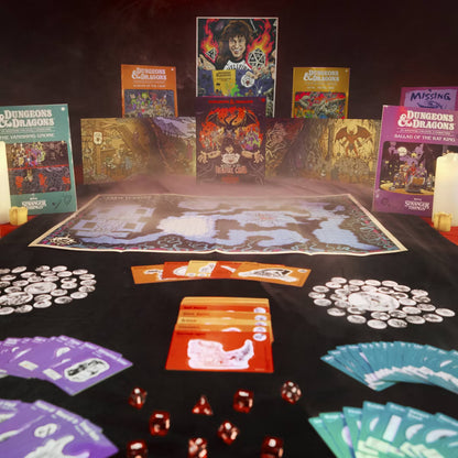 Collection of Dungeons & Dragons books and game components on a table with a map and dice.
