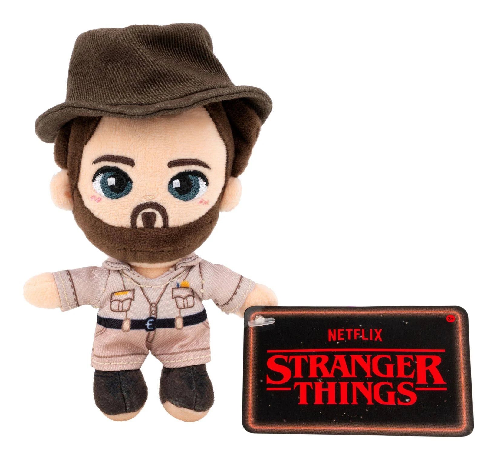 Plush toy with a hat and outfit, next to a 'Stranger Things' tablet case on a white background
