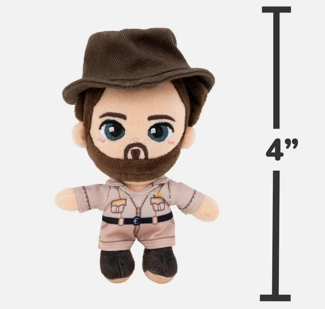 Plush toy resembling a character in a hat and uniform with a measurement label indicating 4" height.