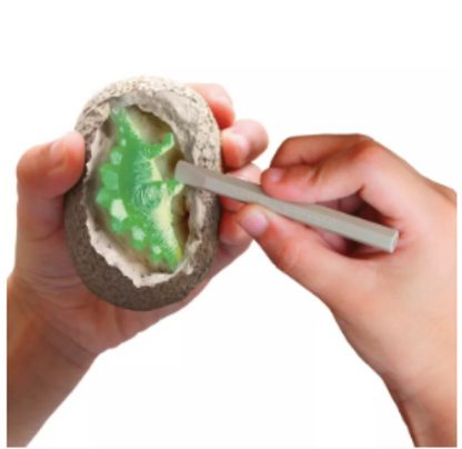 Person using a tool to shape green clay inside a mold on a white background
