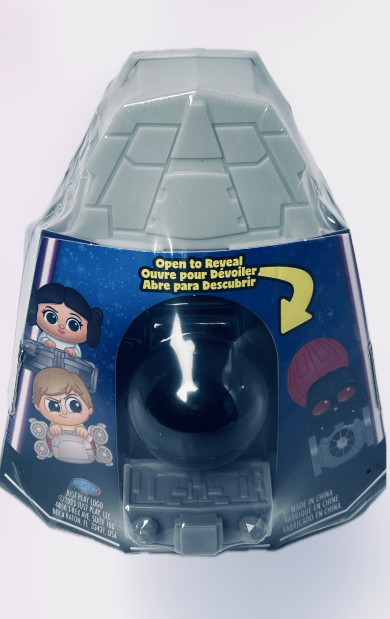 Toy figure in a clear plastic packaging with blue base on a white background