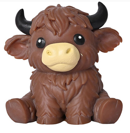 A brown shaggy cow figurine with black horns and a cream-colored snout, sitting against a plain white background.