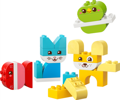 A set of colorful LEGO Duplo animal building blocks on a plain white background, including a red fish, a blue cat, a yellow rabbit, a green bird, and yellow and blue block pieces.