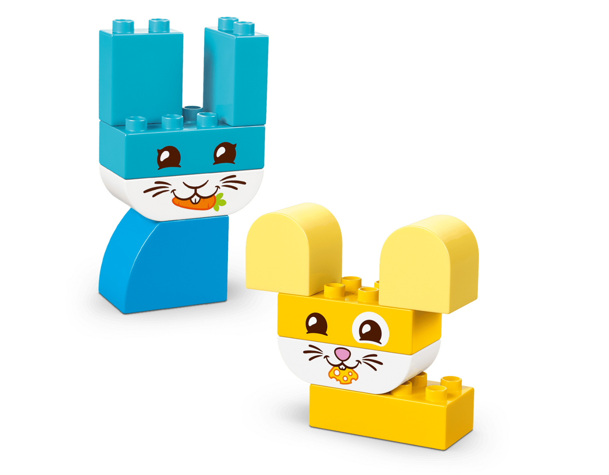 Two toy rabbit figures built from LEGO Duplo blocks on a clean white background. One rabbit is blue and one is yellow, both with white snouts, printed faces, and small flower details.
