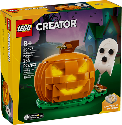 LEGO Creator 40697 Halloween Pumpkin toy box, showing a assembled orange jack-o'-lantern with a glowing face on a green base, alongside a white ghost figure, on a purple haunted-house background.