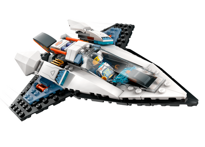 A LEGO Space spaceship set featuring a white and gray body with black wings, blue accents, and a clear cockpit containing a minifigure, shown on a solid white background.