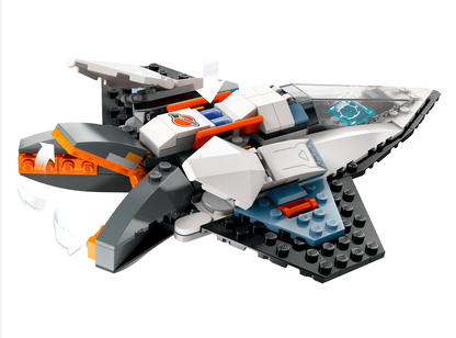A toy building block spaceship model, constructed from white, gray, black, and orange bricks with a clear canopy, shown on a plain white background.