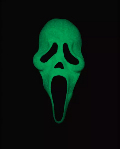 A green glow-in-the-dark Ghostface mask centered on a solid black background.
