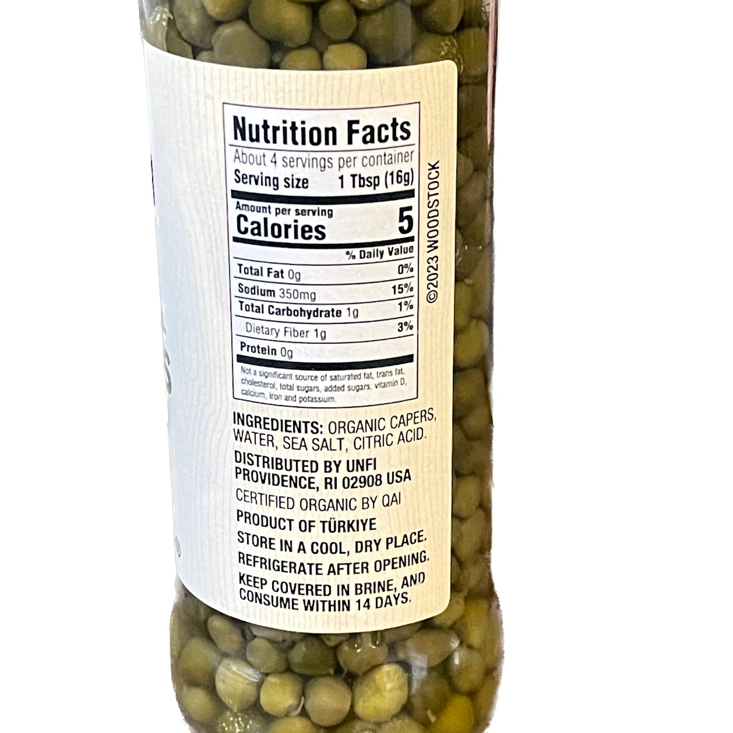 Bottle of capers with a nutrition facts label on a white background