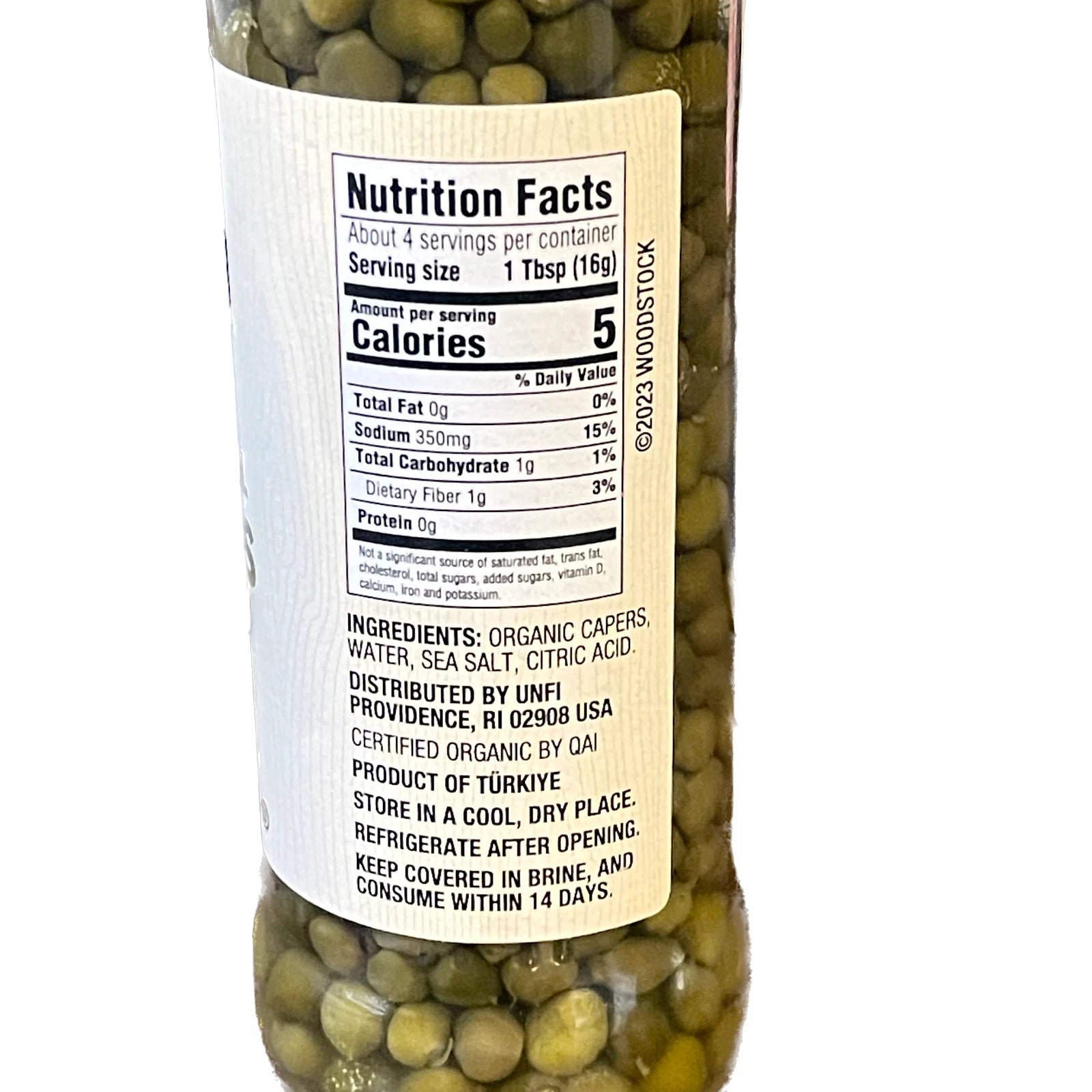 Bottle of capers with a nutrition facts label on a white background