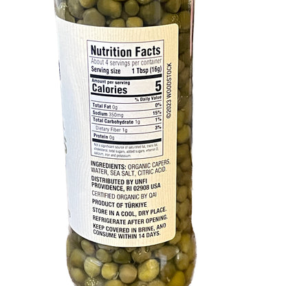 Bottle of capers with a nutrition facts label on a white background