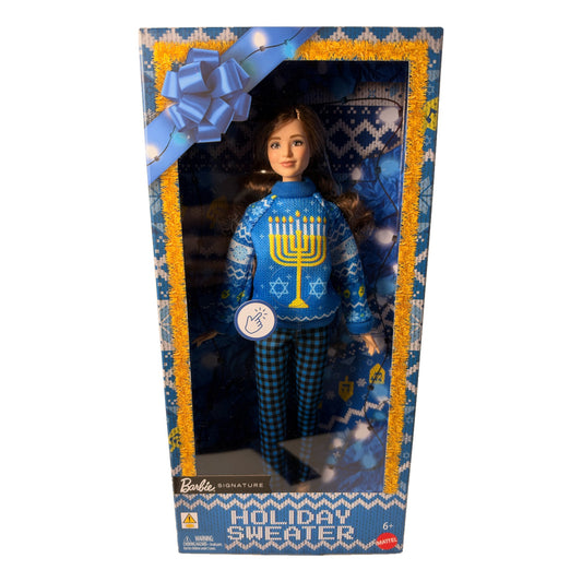 Barbie Signature Holiday Sweater doll JML11 in box, front view, blue Hanukkah menorah light-up sweater and blue gingham pants, brunette