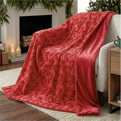 Holiday embroidered faux fur throw, Candy Cane style, draped over a chair