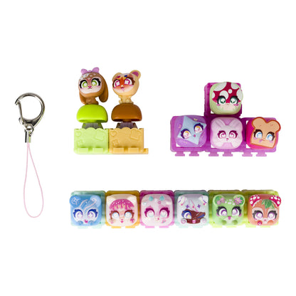 A set of small colorful toy character blocks with cartoon faces, shown with a silver carabiner and pink lanyard on a plain white background.