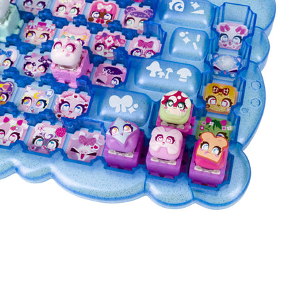 A close-up of a translucent blue keyboard case with custom character switchcaps arranged in rows. The switches feature various colorful cartoon designs, including penguins, a green mushroom, a pink cat, and a green frog, set against a clean white background.