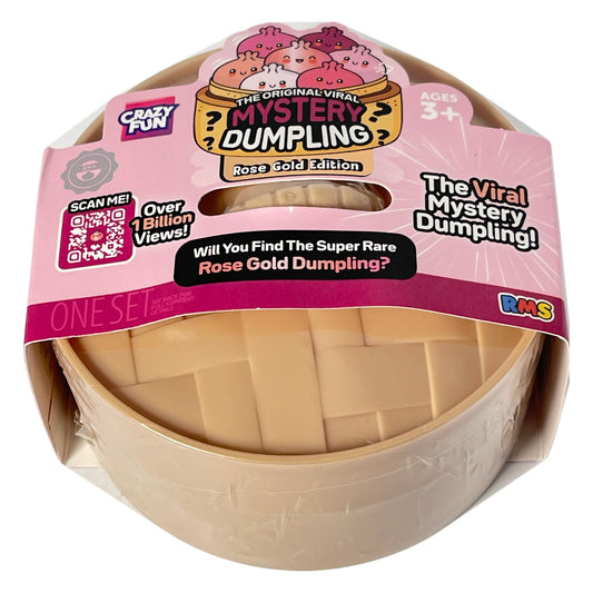 A packaged toy product labeled 'The Original Viral Mystery Dumpling Rose Gold Edition' on a plain light background. The item appears to be a round beige plastic dumpling-shaped toy inside a clear plastic sleeve with a pink retail hanger/card attached.