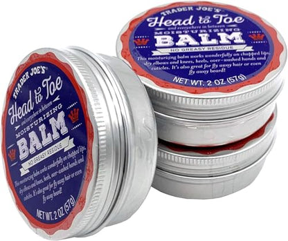 Two silver metal tins of Trader Joe's Head to Toe Moisturizing Balm, one open in the foreground and one stacked, showing the blue and red product labels.