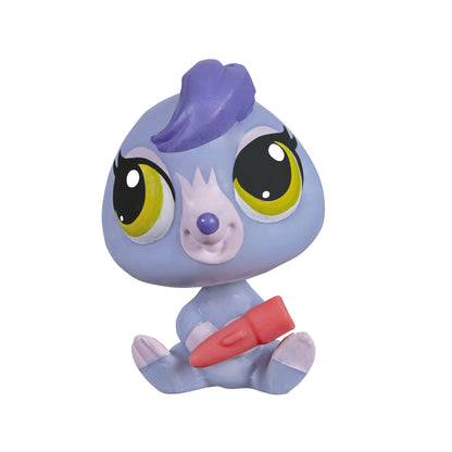 Toy figure with large eyes and a purple hat on a white background