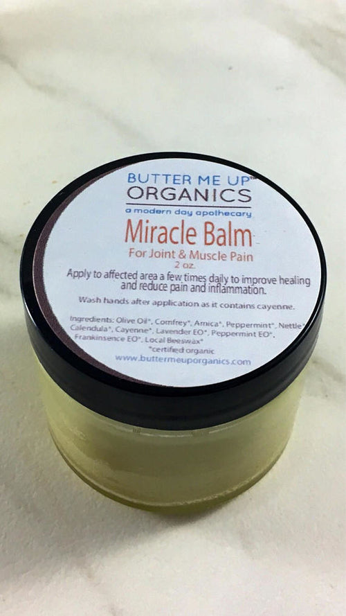 Butter Me Up Organics Miracle Balm jar on a white background