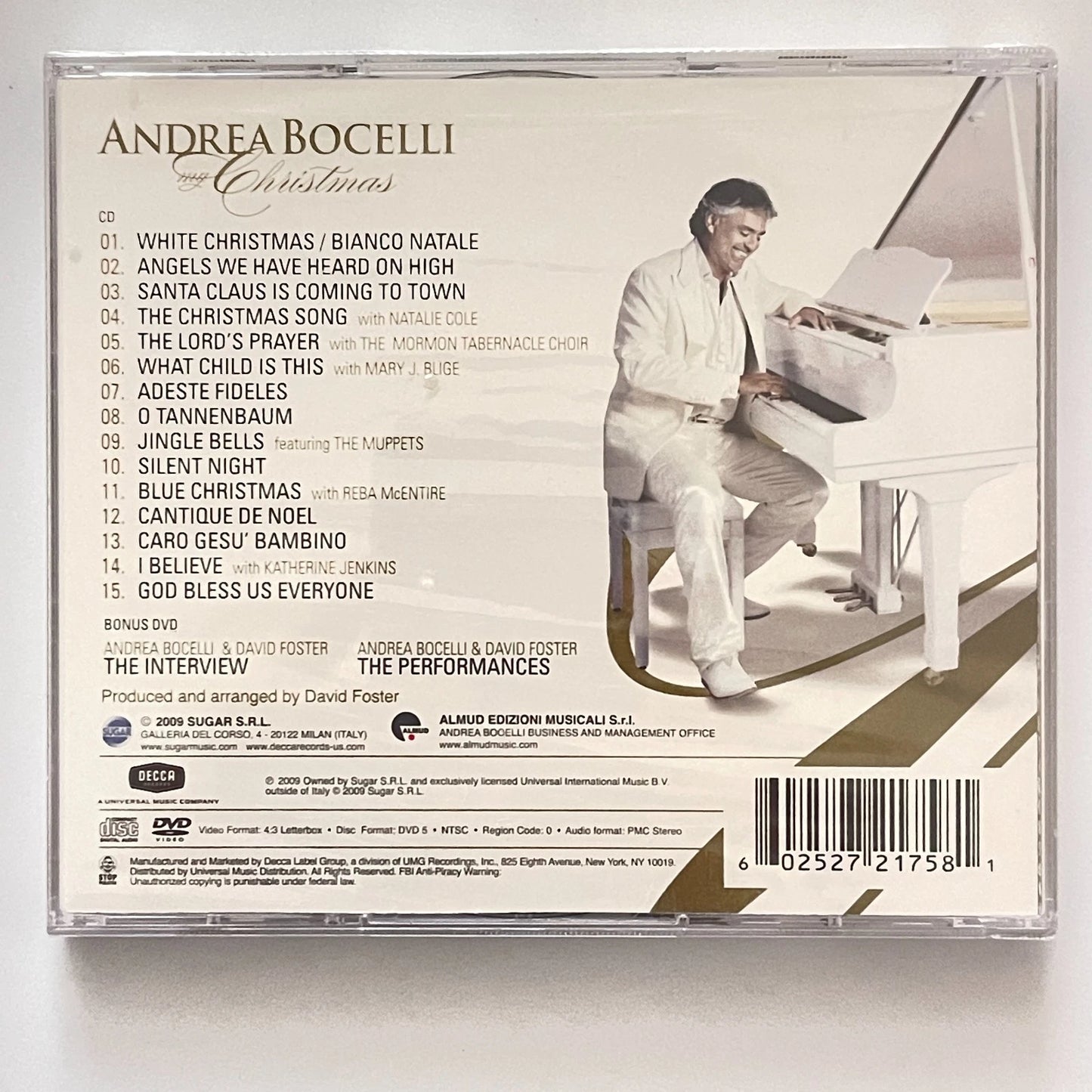 Back cover of Andrea Bocelli's Christmas album with a piano and list of songs.